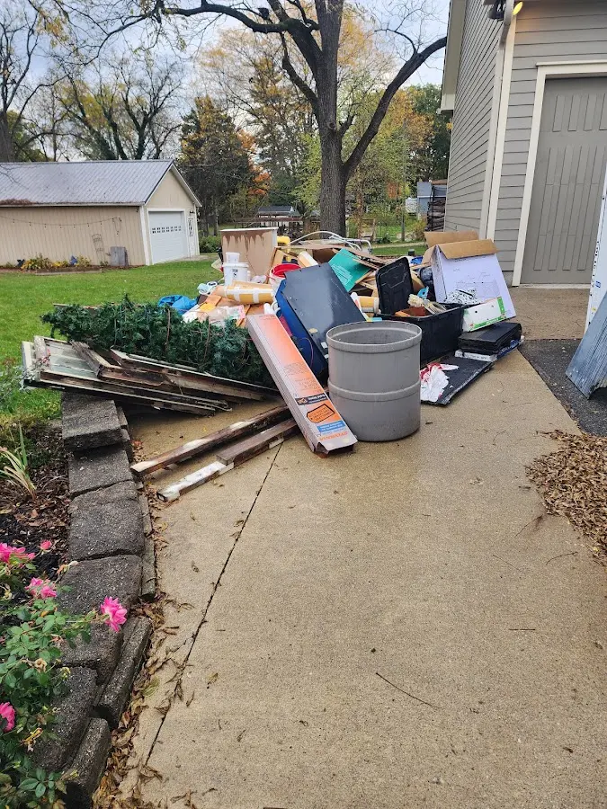 Dumpster being loaded with debris for 12 Yard Dumpster Rental in Manheim
